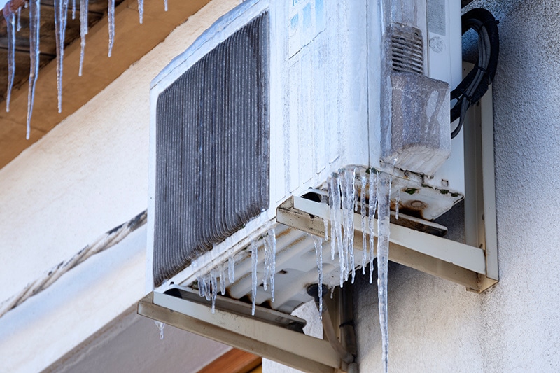 Why Is My Heat Pump Freezing Up? Heat Pump that is frozen and covered in ice.