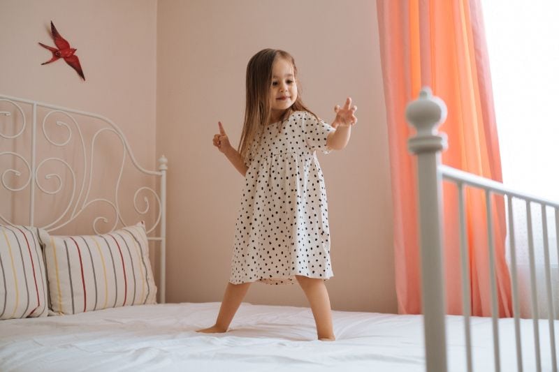 Image of child standing on bed. What You Should Know About Air Handlers.